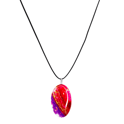 close up of red, purple and gold heart disease necklace with oval cell image resin pendant on adjustable black cord