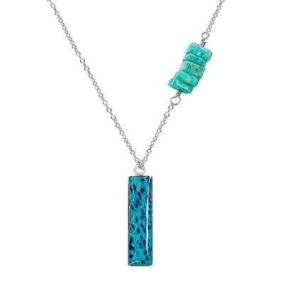 close up of Asymmetrical Ovarian cancer Awareness Necklace with a Teal Blue Pendant in Sterling silver. 