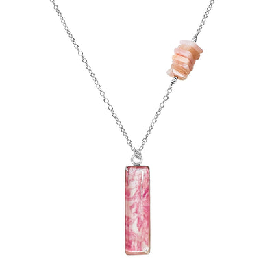 close up of Asymmetrical Breast cancer Awareness Necklace with Pink Pendant in Sterling silver. 