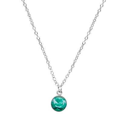 close up of teal early embryo pendant on silver chain necklace for infertility awareness