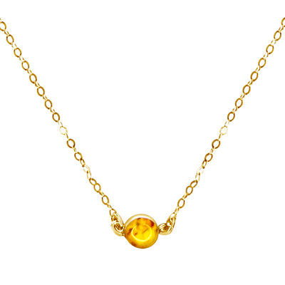 close up of yellow sarcoma awareness minimalist chain necklace that gives back to charity in gold filled