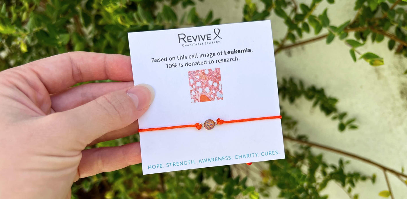 orange leukemia awareness bracelet with adjustable cord on revive jewelry product card