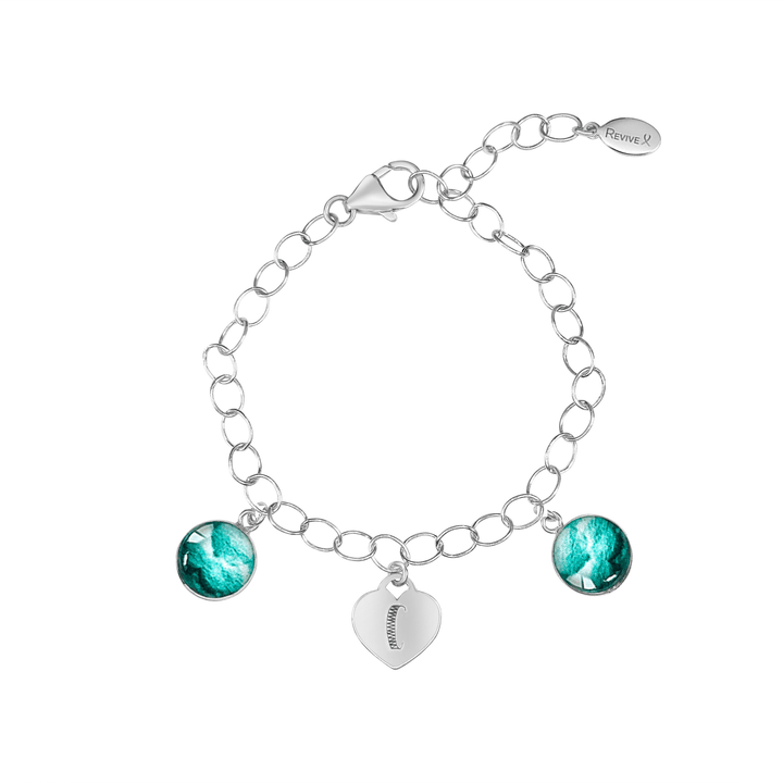Silver bracelet with teal embryo images and a heart-shaped charm engraved with "C" on a white background