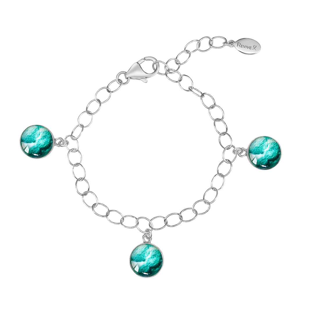 Silver chain bracelet with teal pendants showing embryo images on a white background