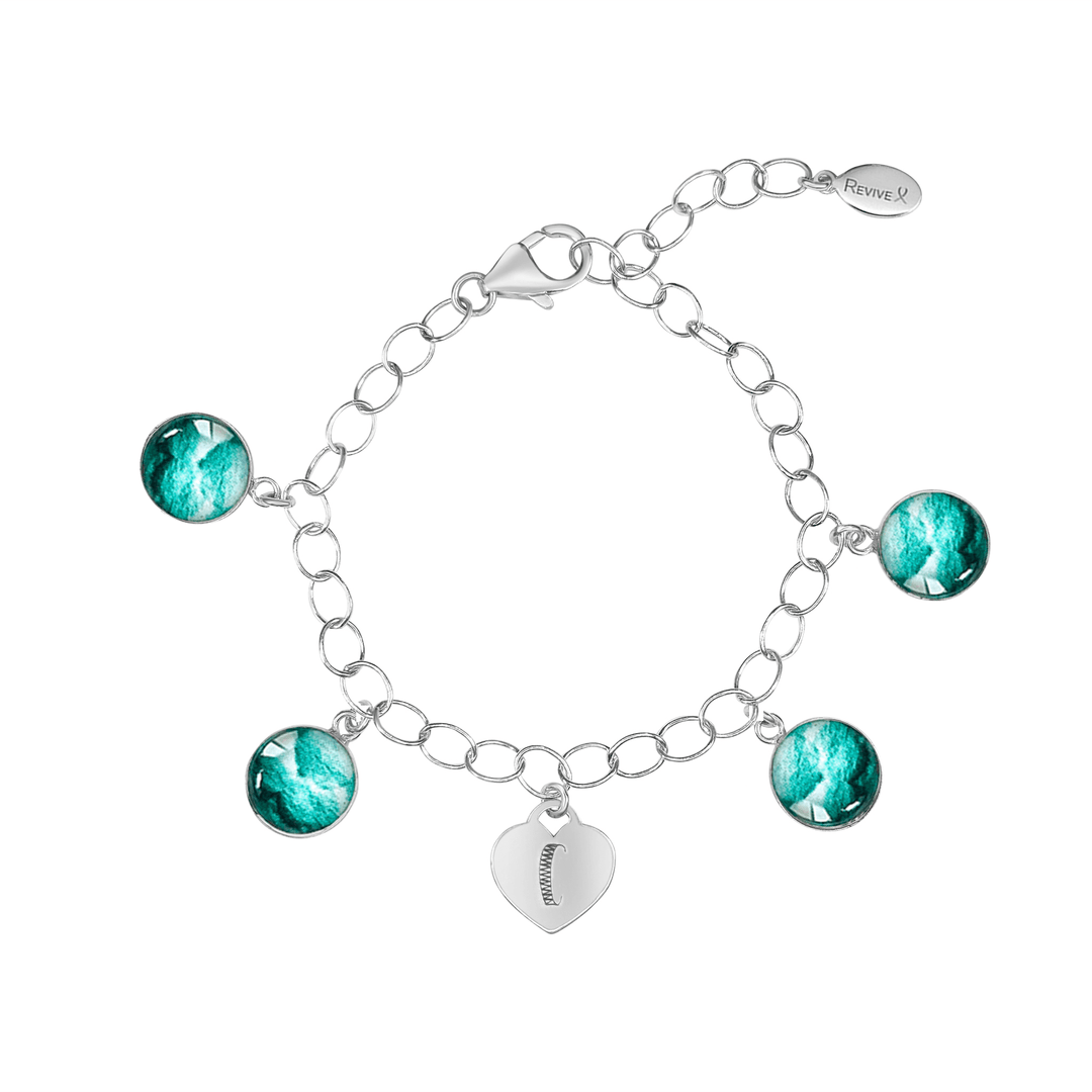 Silver bracelet with teal embryo images and a heart-shaped charm engraved with "C" on a white background