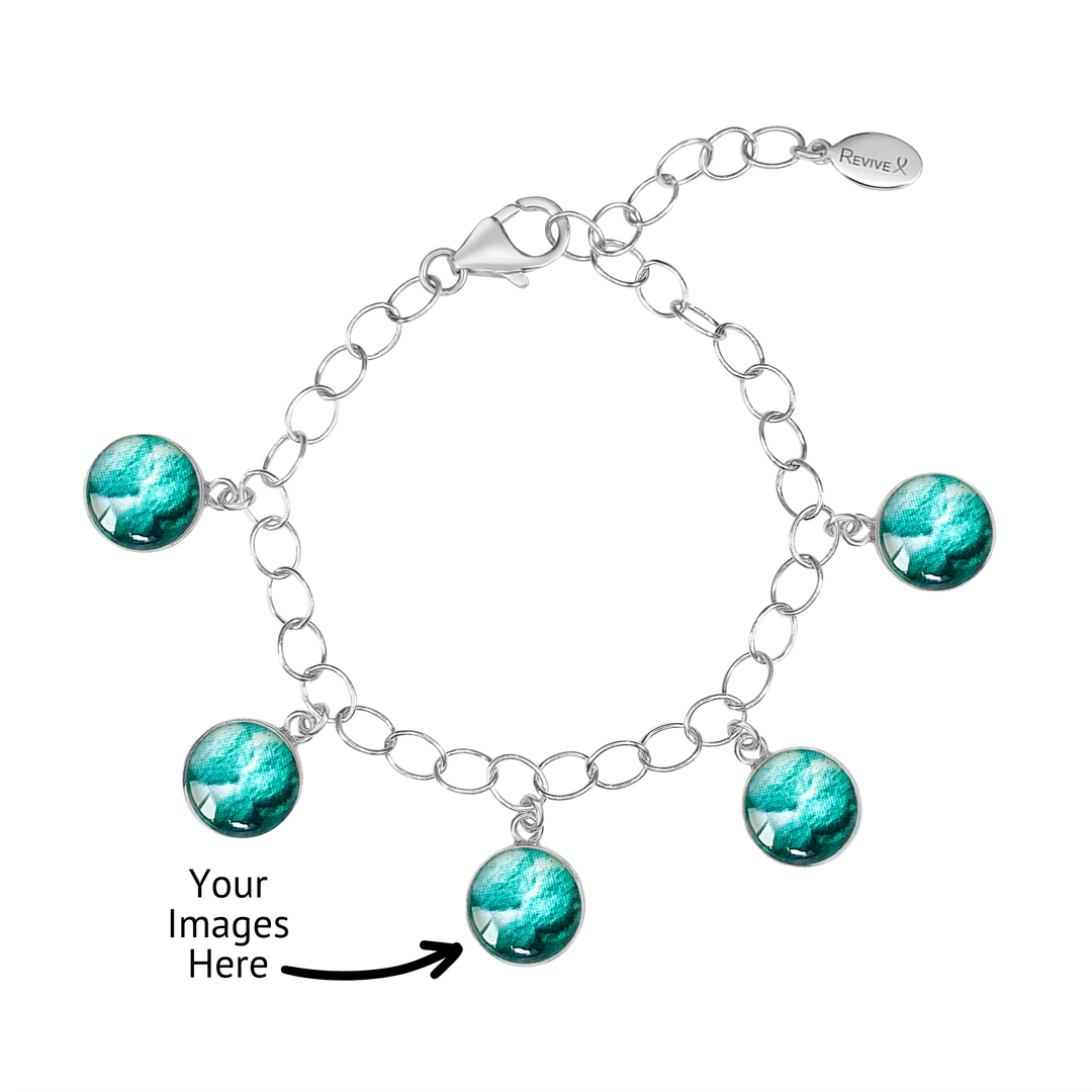 Silver bracelet with teal embryo images on a white background