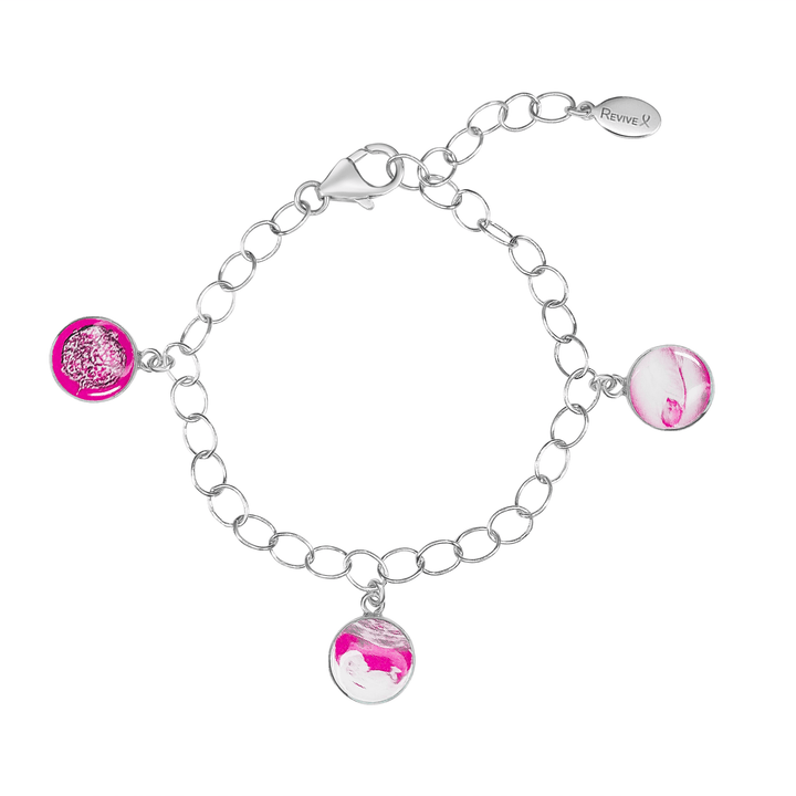 Silver bracelet with pink pendants showing the IVF journey from embryo to baby on a white background