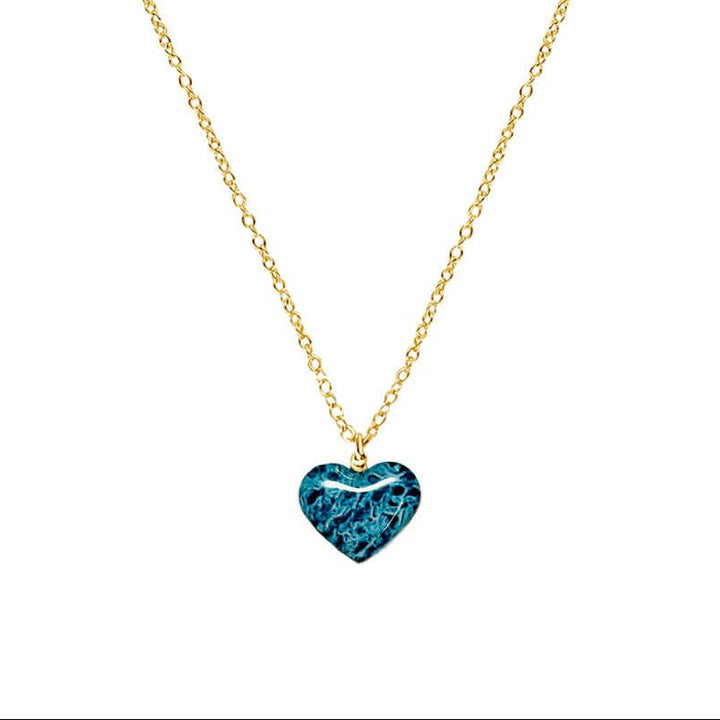 close up of heart shaped necklace with ovarian cancer awareness cell image in resin pendant on 14k gold filled chain
