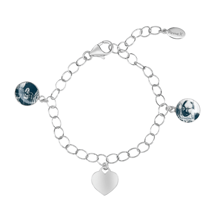 Silver bracelet with grayscale sonogram pendants and a blank heart-shaped charm on a white background