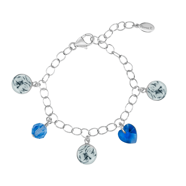 Silver bracelet with grayscale sonogram pendants with blue birthstone crystals on a white background