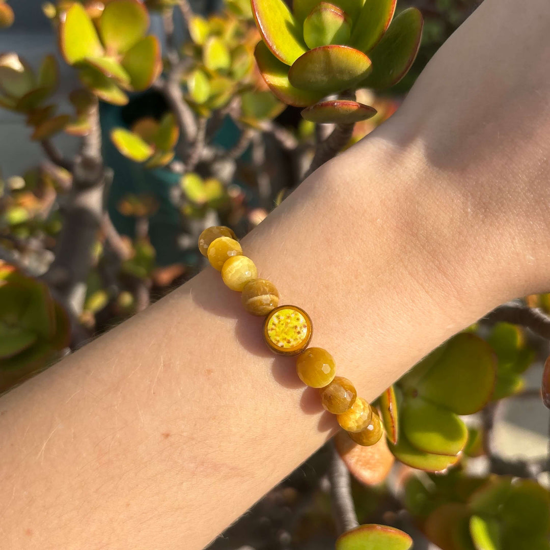 golden tiger eye stone stretch bracelet with sarcoma cell image in resin pendant on model