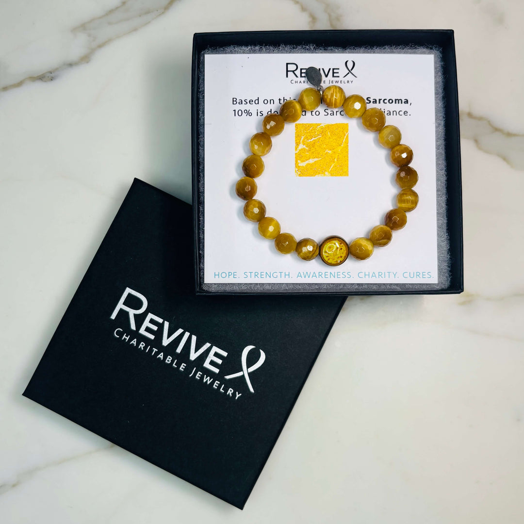 golden tiger eye stone stretch bracelet with sarcoma cell image in resin pendant with product packaging