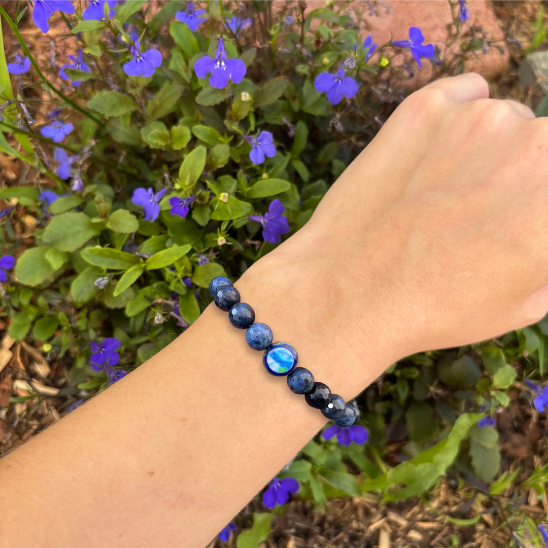 dark blue dumortierite stone stretch bracelet with diabetes cell image in resin pendant on model