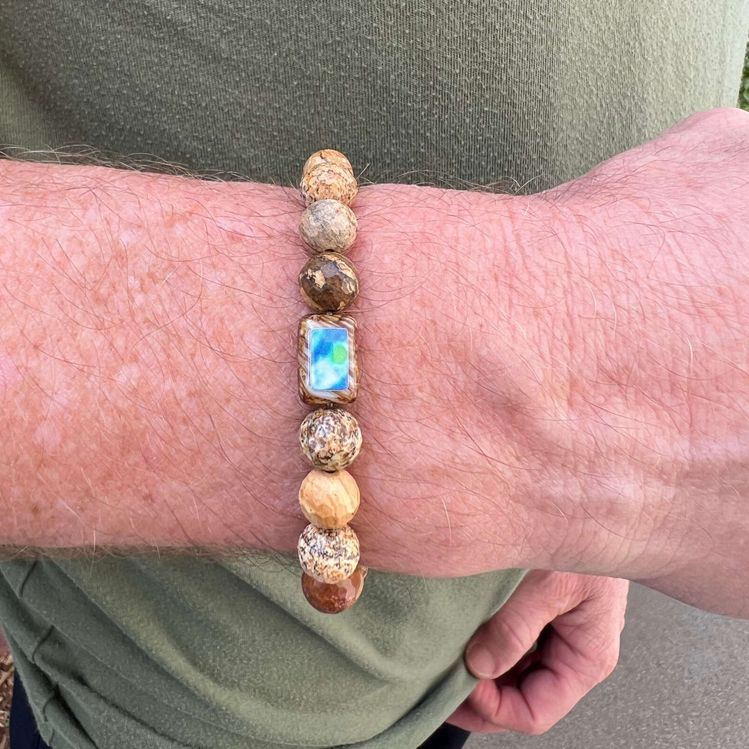 close up of man wearing mens bracelet with picture jasper and diabetes cell image in resin pendant on stretch cord