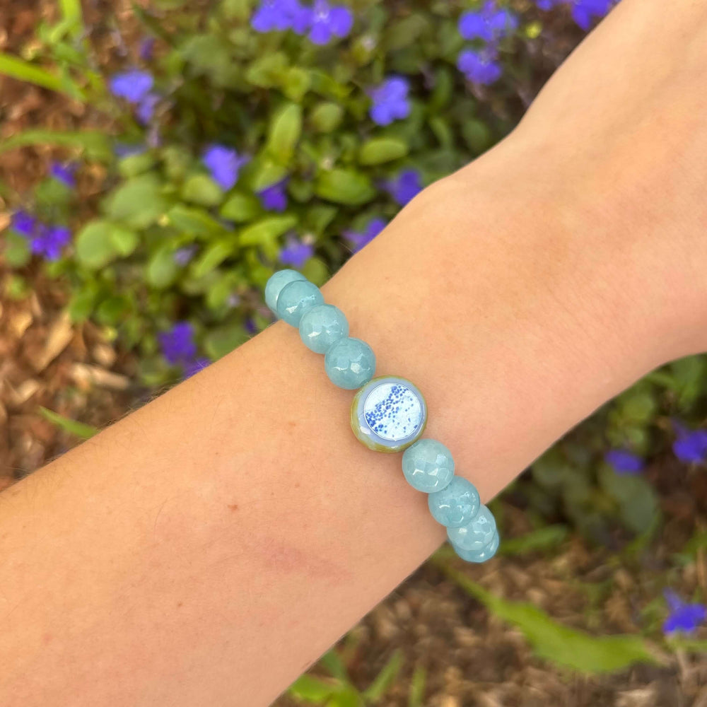 light blue sponge quartz stone stretch bracelet with multiple sclerosis cell image in resin pendant on model