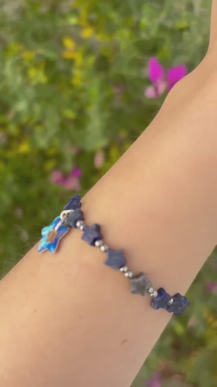 Blue and Silver Bracelet with Lapis star shapes beads and a dangly blue star pendant on a model's wrist