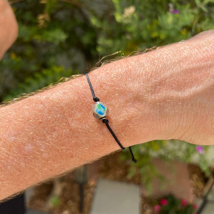 model wearing mens Sterling silver diabetes cell image in resin pendant on black adjustable cord