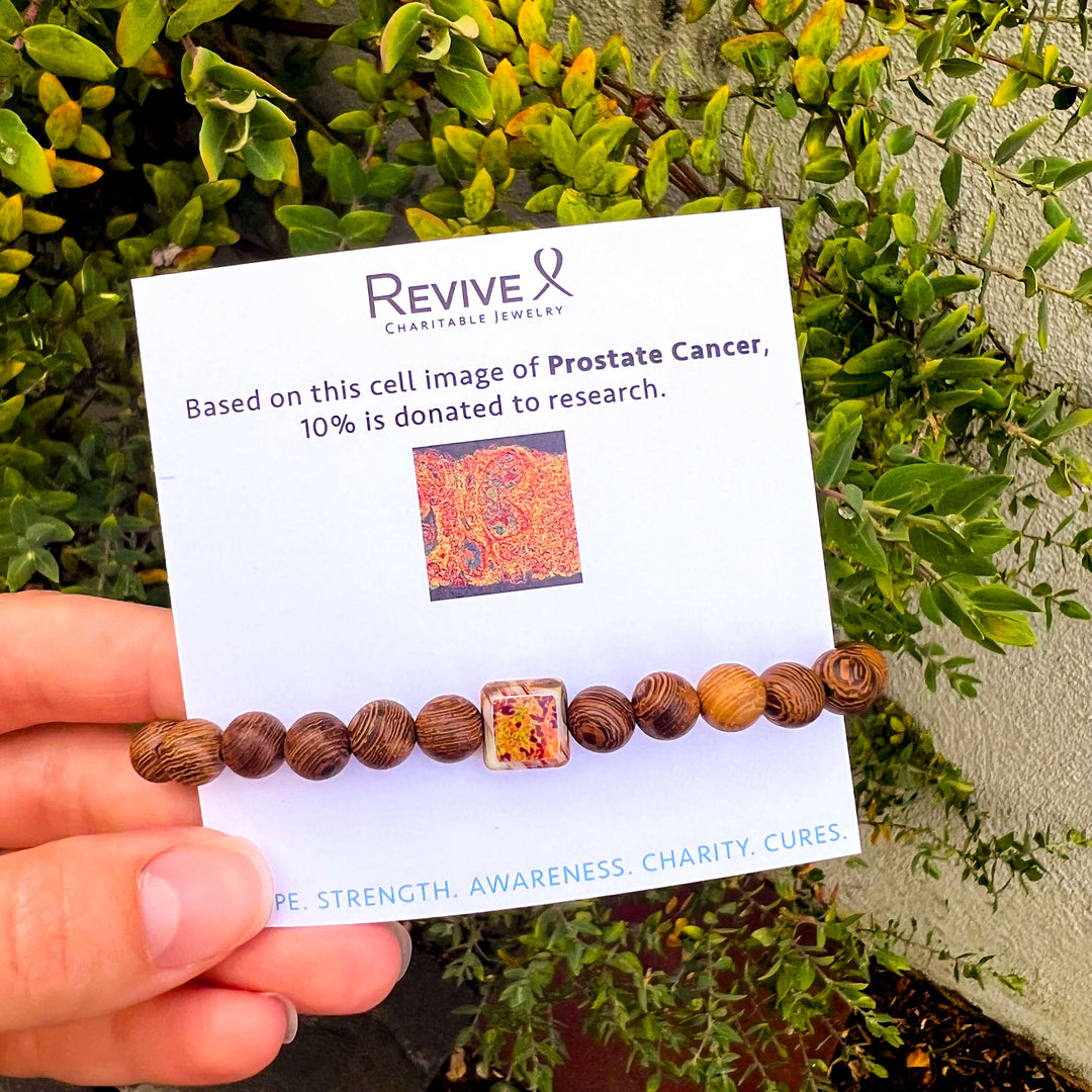 wood bracelet for men based on a prostate cancer cell image in resin on stretch cord with product card packaging