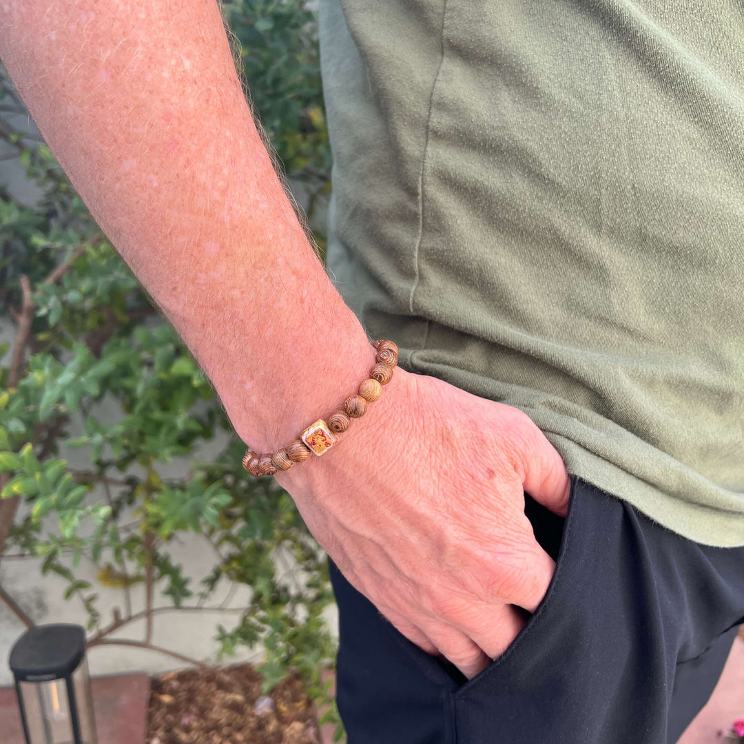 model wearing wood bracelet for men based on a prostate cancer cell image in resin on stretch cord