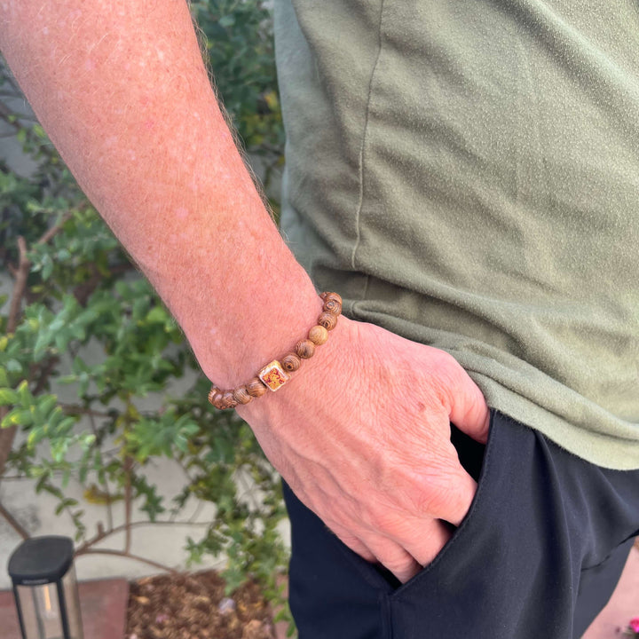 model wearing wood bracelet for men based on a prostate cancer cell image in resin on stretch cord