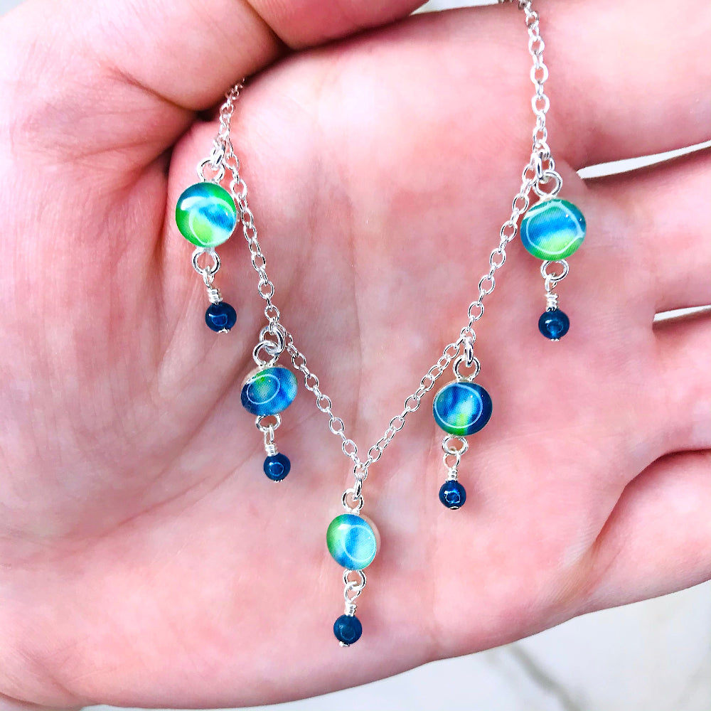 green and blue necklace for diabetes awareness that gives back to research with apatite stones in hand for size