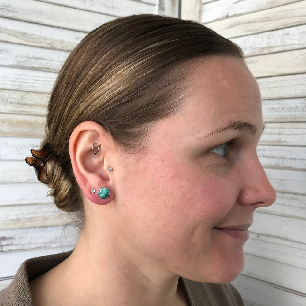 model wearing custom infertility stud earrings in Sterling silver