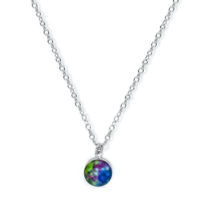 Close up of round melanoma necklace with colorful  pendant on sterling silver chain. 