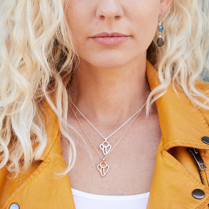 Model wearing silver and gold guardian angel lung cancer necklace.